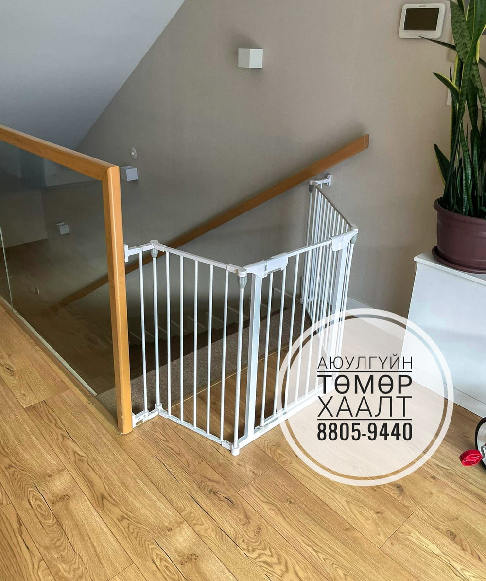 White baby gate installed at the base of a wooden staircase with a phone number overlay.