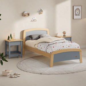 Children's bedroom with a wooden bed, nightstands, and decor items.