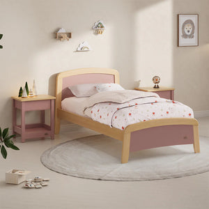 Children's bedroom with a pink and wooden bed, nightstands, and decor.