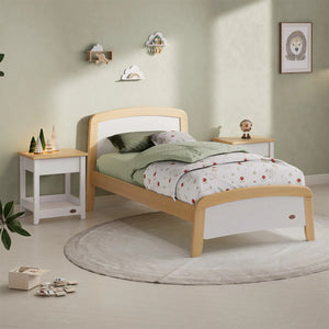 Children's bedroom with a wooden bed, nightstands, and decor items.