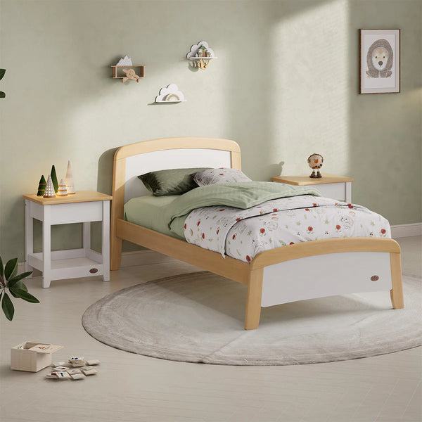Children's bedroom with a wooden bed, nightstands, and decor items.