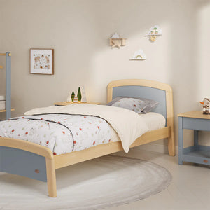Wooden bed with light blue accents in a bedroom setting