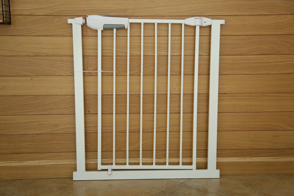 White metal gate against a wooden wall