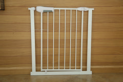 White metal gate against a wooden wall