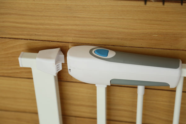 White and gray electronic device on a wooden surface