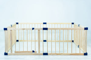 Wooden playpen with blue accents on a light blue background