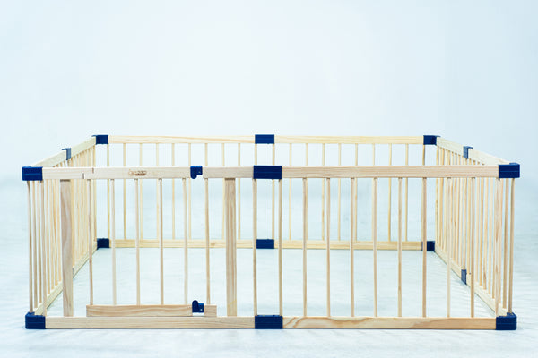 Wooden playpen with blue accents on a light blue background