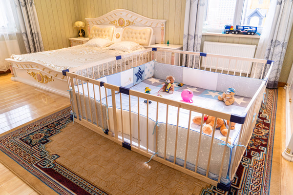 Baby crib with toys inside in a bedroom setting