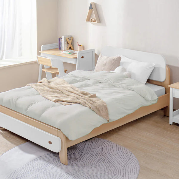 Bedroom with a wooden bed, desk, and chair.