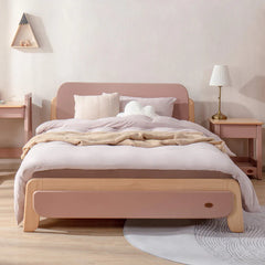 Wooden bed with pink headboard and footboard in a bedroom setting.