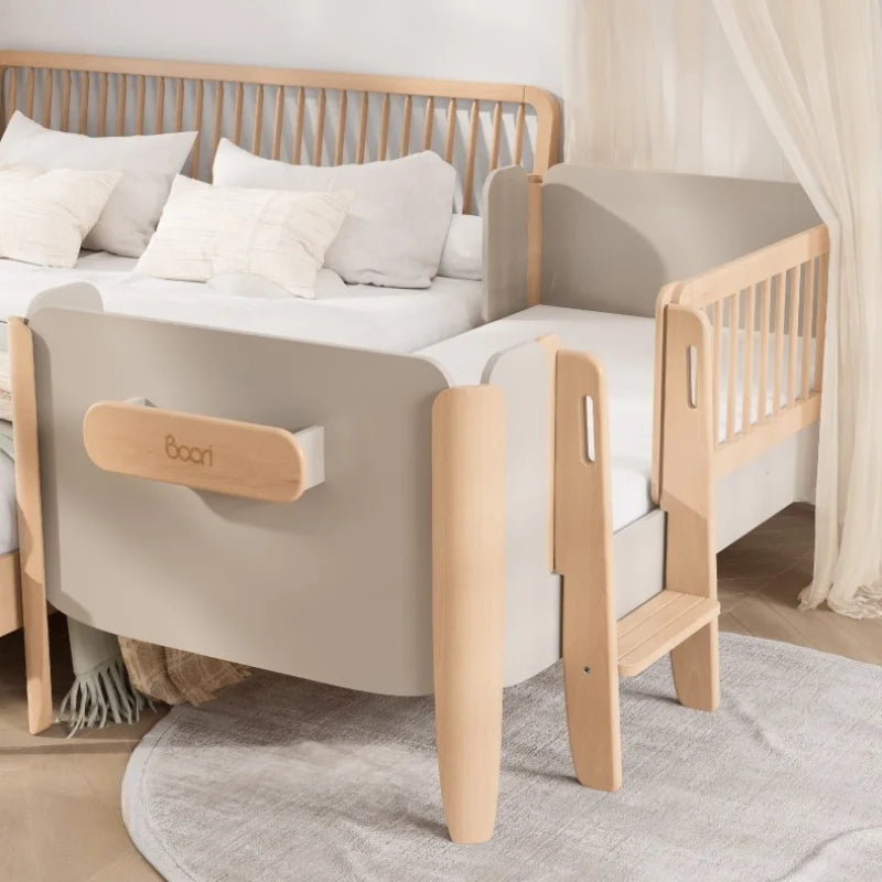 Wooden crib in a room with a white wall, round rug, and toys.