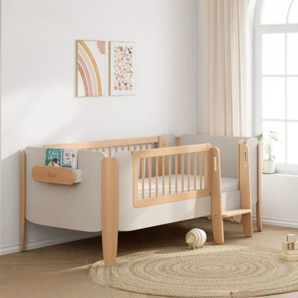 Children's bed with wooden sides in a bright room with a window and decor.