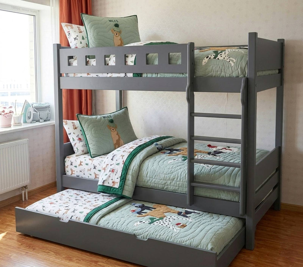 White bunk bed with rainbow-themed bedding and pillows in a room.