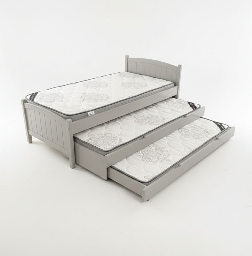 Children's bed with pull-out trundle in a room with star decals on the wall.