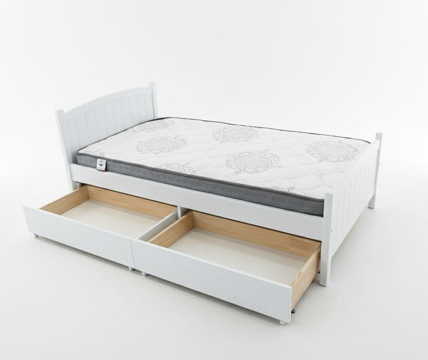 White bed frame with a mattress and wooden drawers on a white background