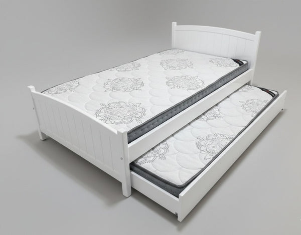White bed with a mattress and pull-out trundle on a gray background