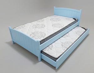 Blue bed with a mattress and pull-out trundle on a gray background