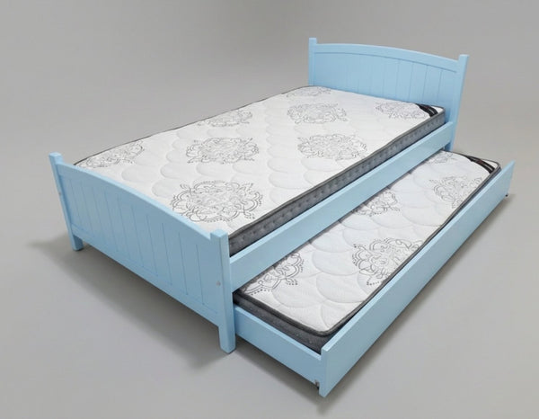 Blue bed with a mattress and pull-out trundle on a gray background
