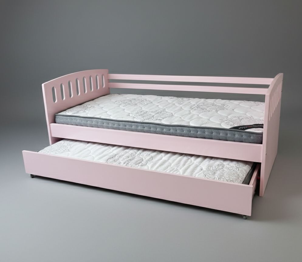 White children's bed with rainbow-patterned bedding on a patterned carpet.