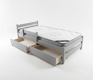 Gray bed frame with mattress and open drawers on a white background
