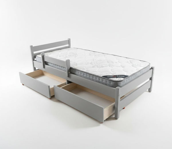 Gray bed frame with mattress and open drawers on a white background