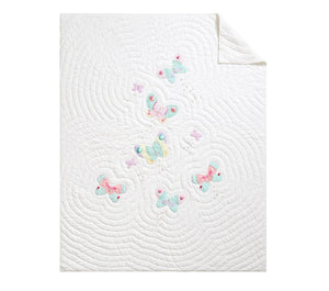 White quilt with colorful butterfly patterns on a white background