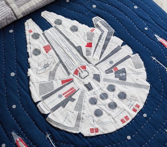 Embroidered Millennium Falcon spaceship on a blue fabric background