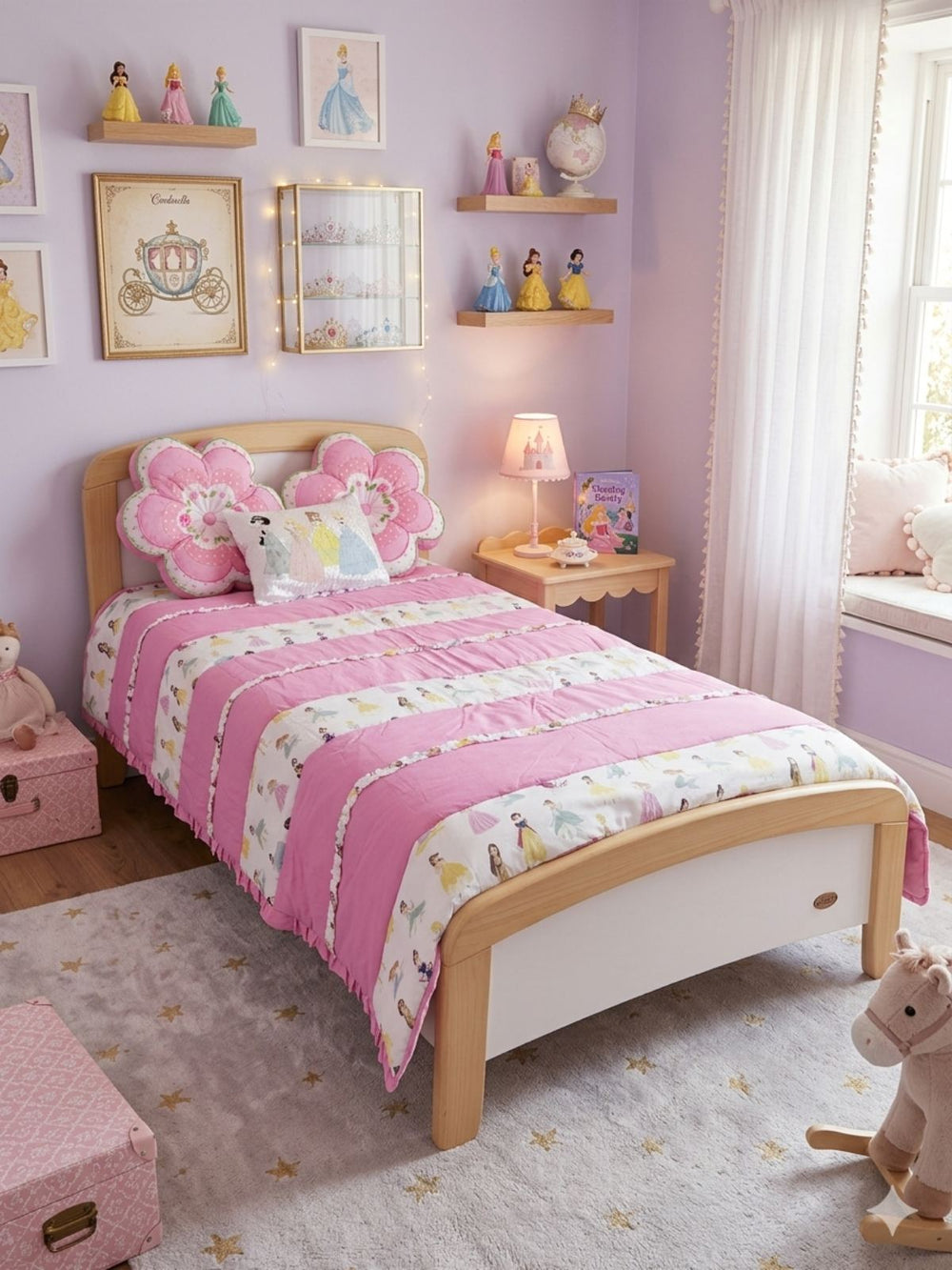 Children's bedroom with a pink and white floral bedspread on a wooden bed.