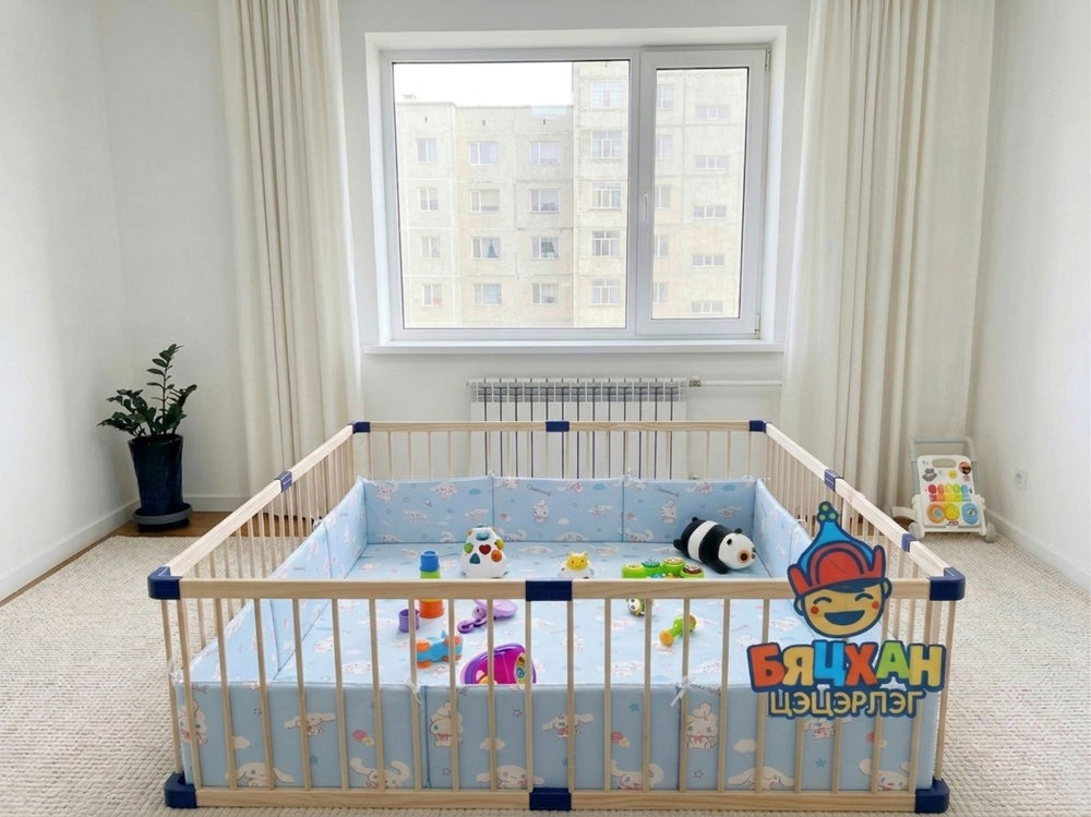 Children's room with a crib and toys, featuring a visible brand logo.