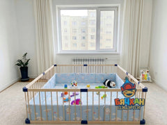 Children's room with a crib and toys, featuring a visible brand logo.