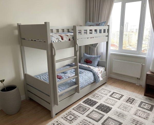 Bunk bed in a room with a window and rug
