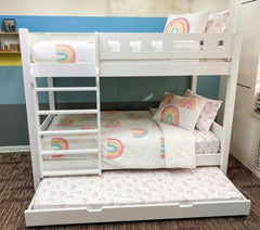 White bunk bed with rainbow-themed bedding and pillows in a room.