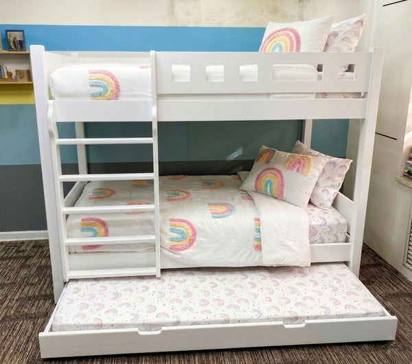 White bunk bed with rainbow-themed bedding and pillows in a room.